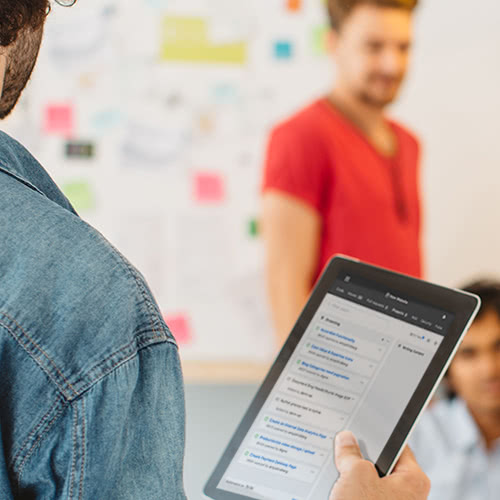 Man with tablet talking to teammates