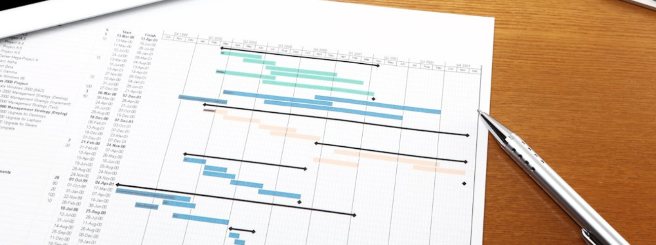 example Gantt chart on a desk with a pen