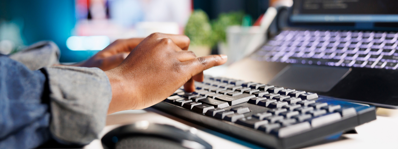 hands typing on a keyboard
