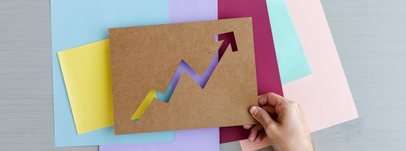 hand holding a paper graph showing upward trajectory