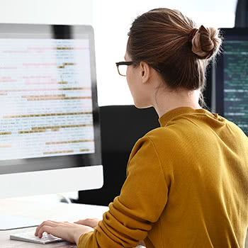 Woman looking at code on computer